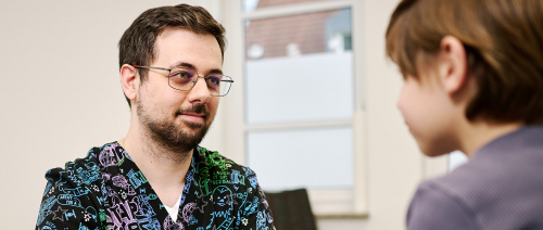 Kinderarzt im Gespräch mit Schulkind